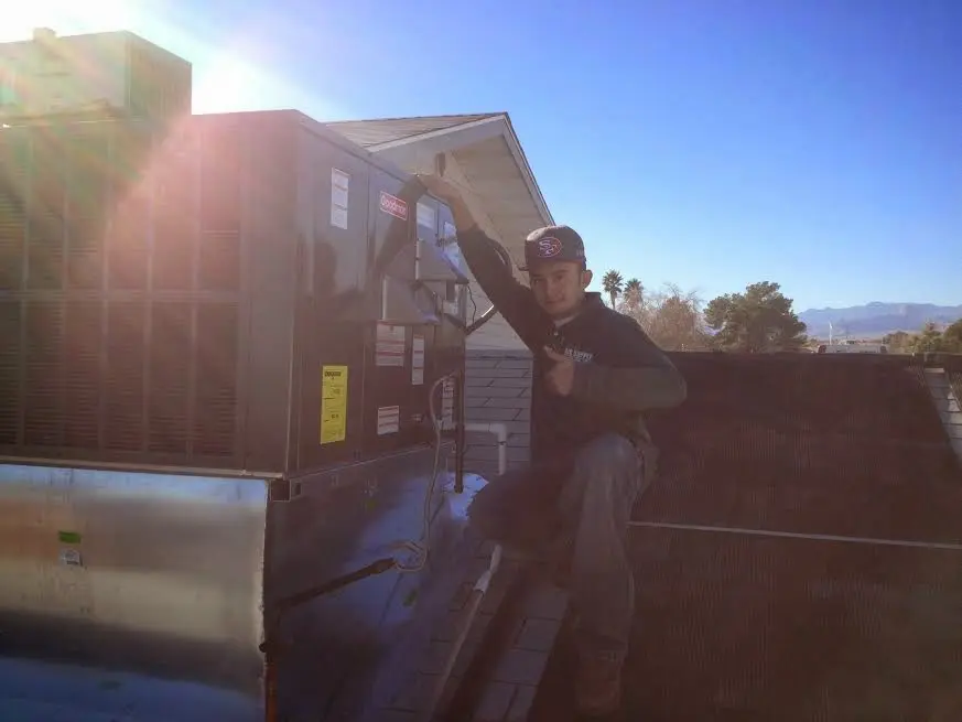 HVAC technician performing Boiler Repair on a rooftop unit in Pontoon Beach