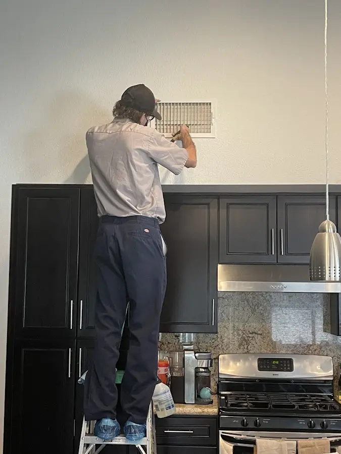 Technician inspecting an air vent during HVAC service in Pontoon Beach